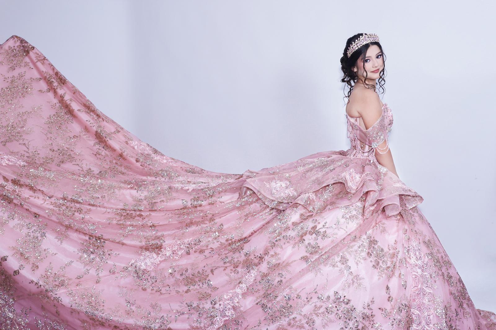 Aneth in her pink quinceañera gown with a flowing train